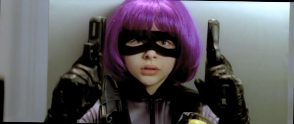 Screenshot from Kick-Ass: Hit-girl close-up holding two pistols.